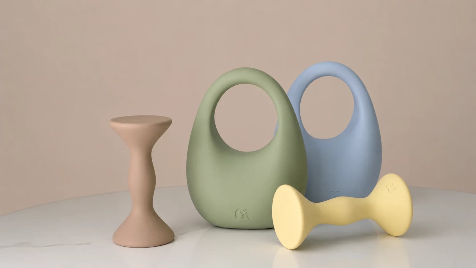 MOVART pastel home gym equipment arranged on a curved tabletop